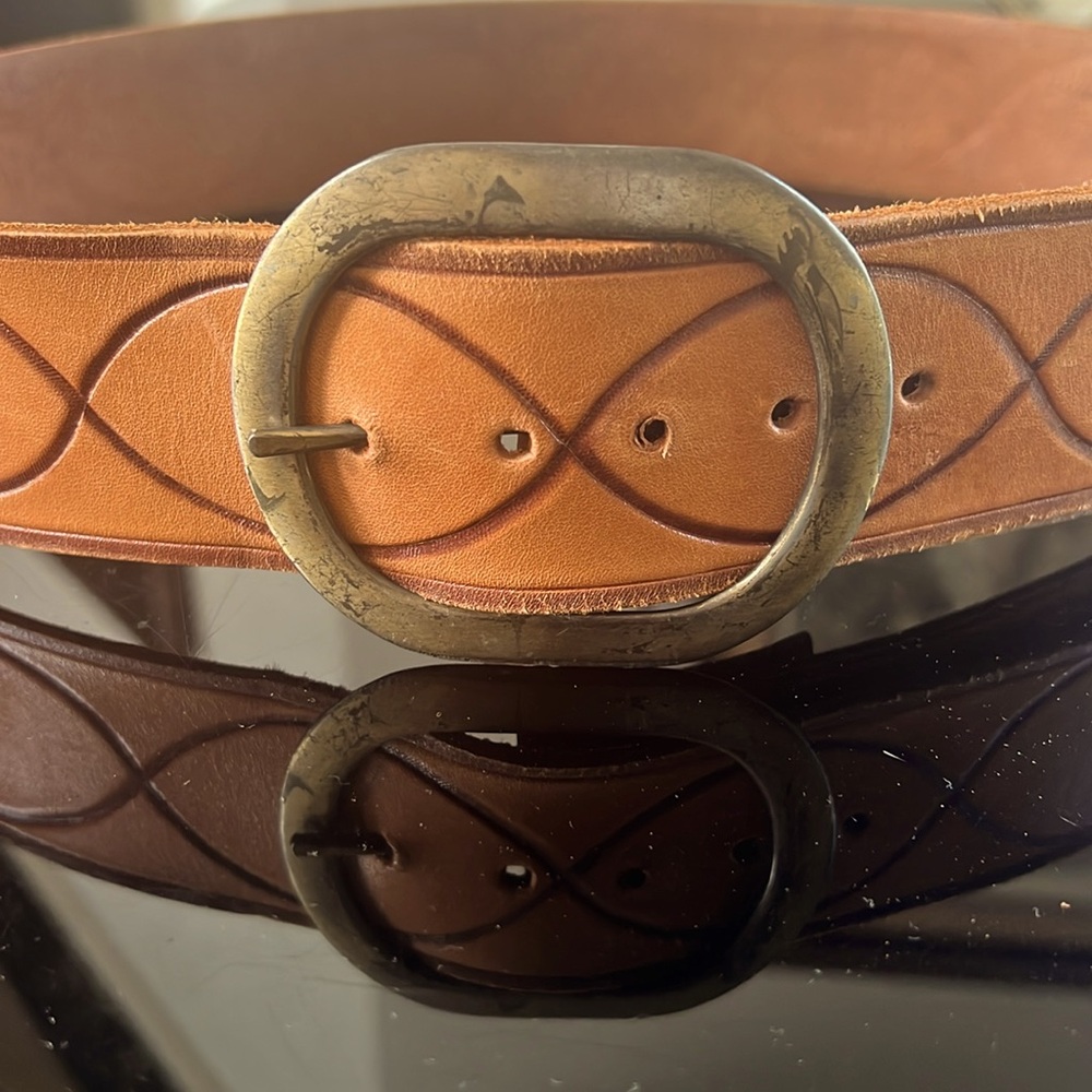 Brown Orange leather belt with pattern on it and a metal buckle 40” long